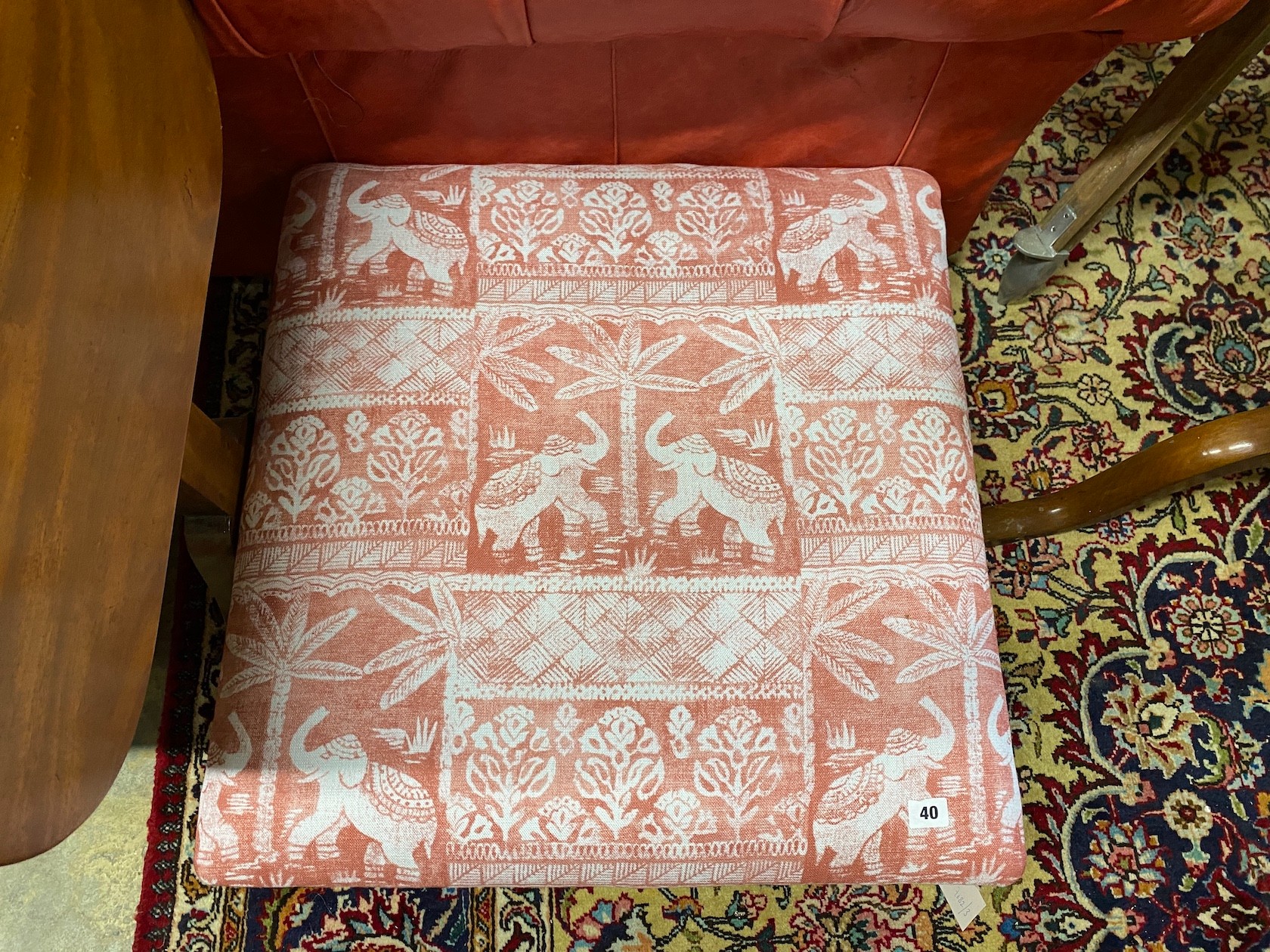 A reproduction Victorian style mahogany footstool upholstered in Jane Churchill 'Elephant Parade' fabric, length 66cm, depth 68cm, height 26cm